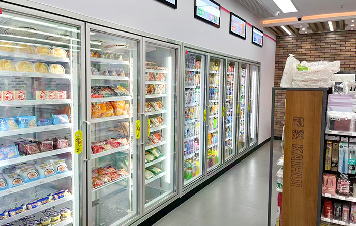 How can commercial refrigerated display cases be made more energy-efficient?
